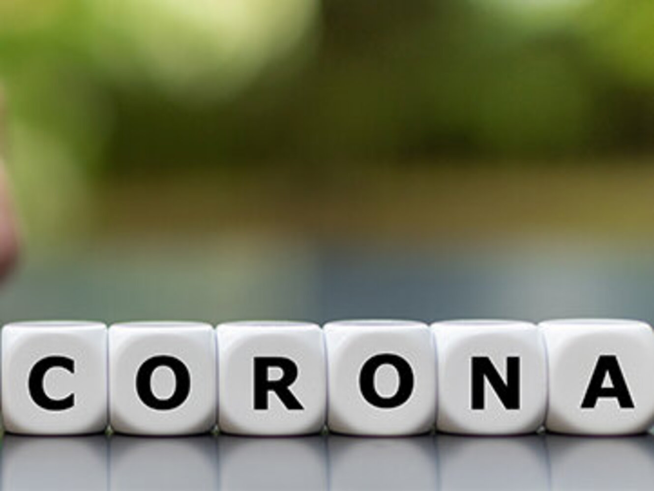 Hand turns dice and changes the expression "pre corona" to "post corona".