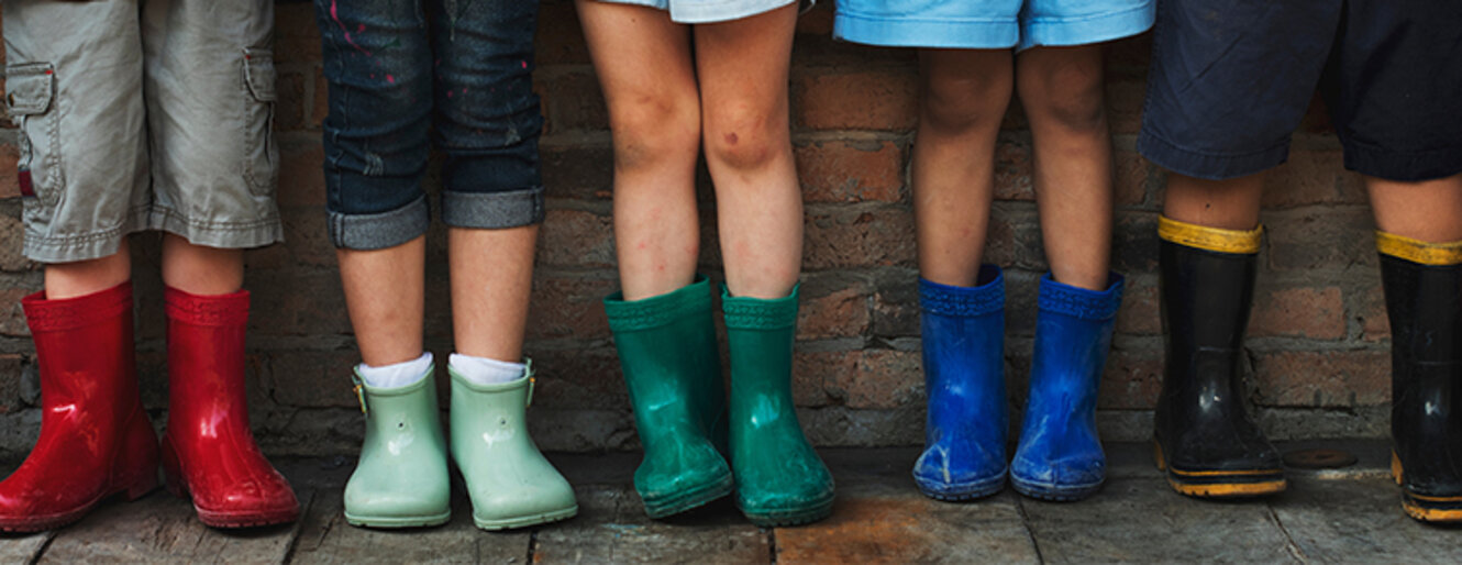 Group of kindergarten kids in their rain boots