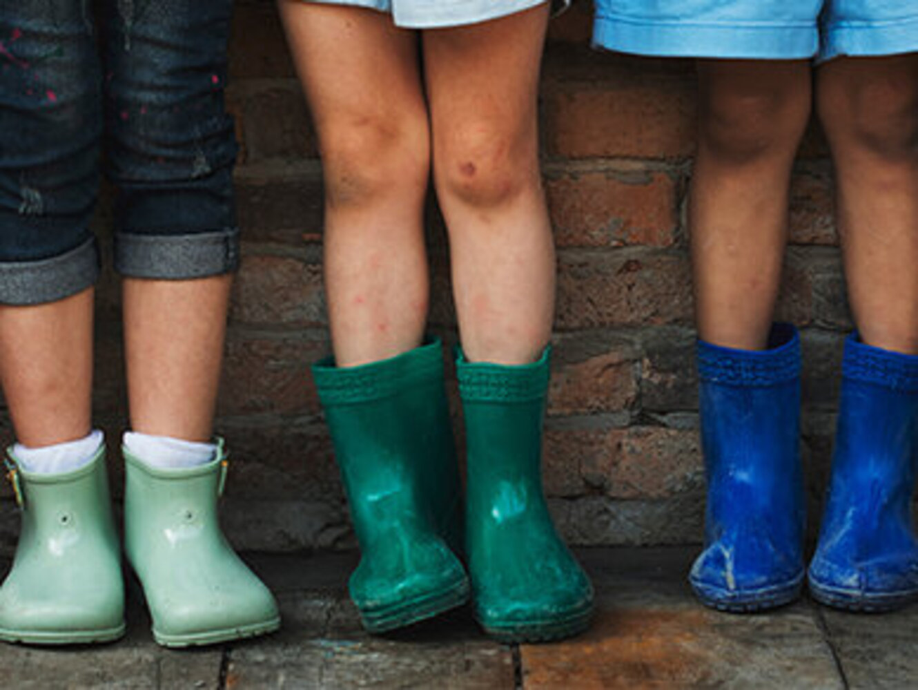 Group of kindergarten kids in their rain boots