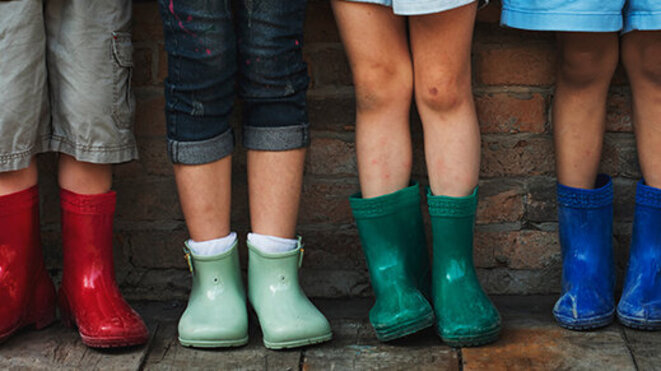 Group of kindergarten kids in their rain boots