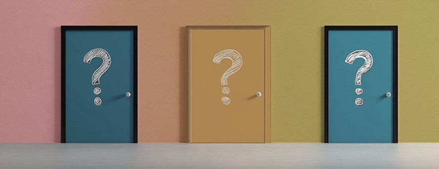 Colorful doors with question marks representing the challenging process of decision making