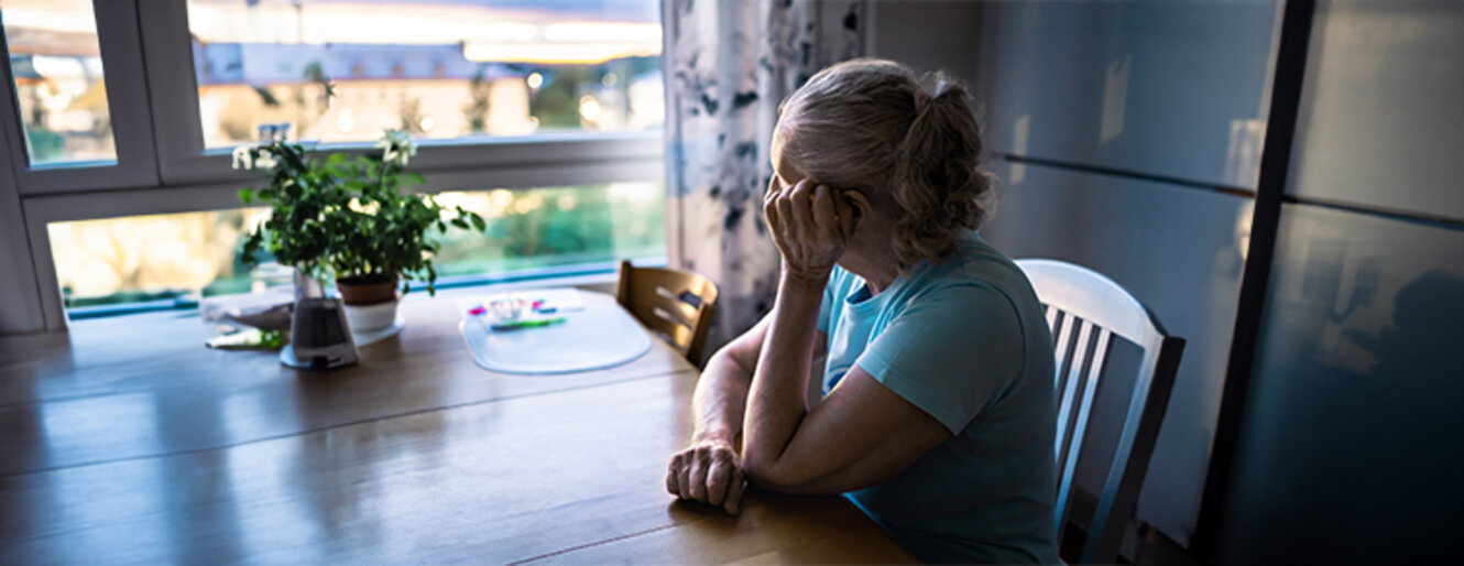 Elder person looking out the home window. 