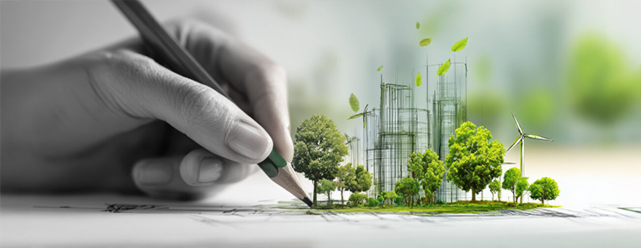 A hand drawing a sustainable urban development with green trees and wind turbines.