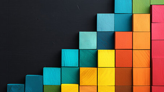 Colorful wooden blocks stacked in a pattern against a dark background creating a playful and structured