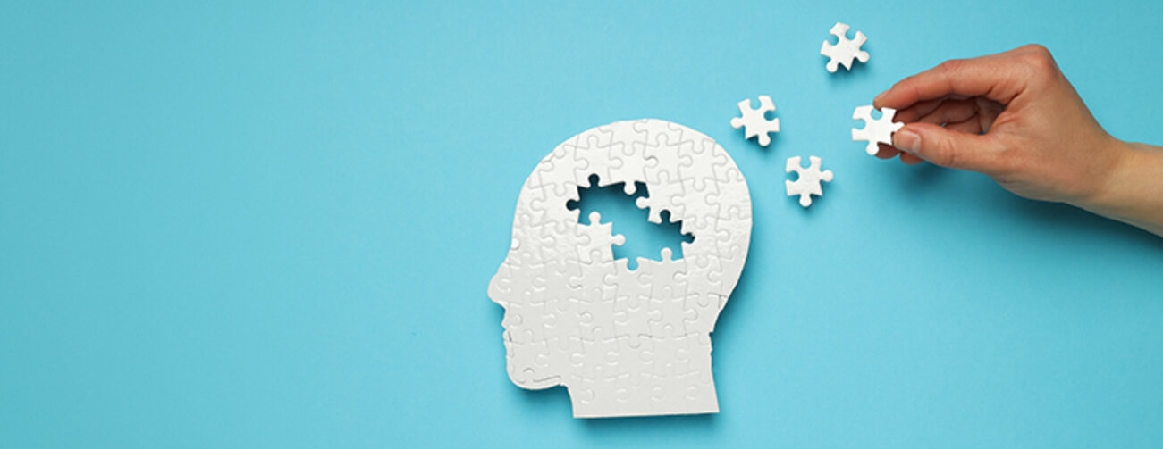 Puzzle head with missing elements on a blue background